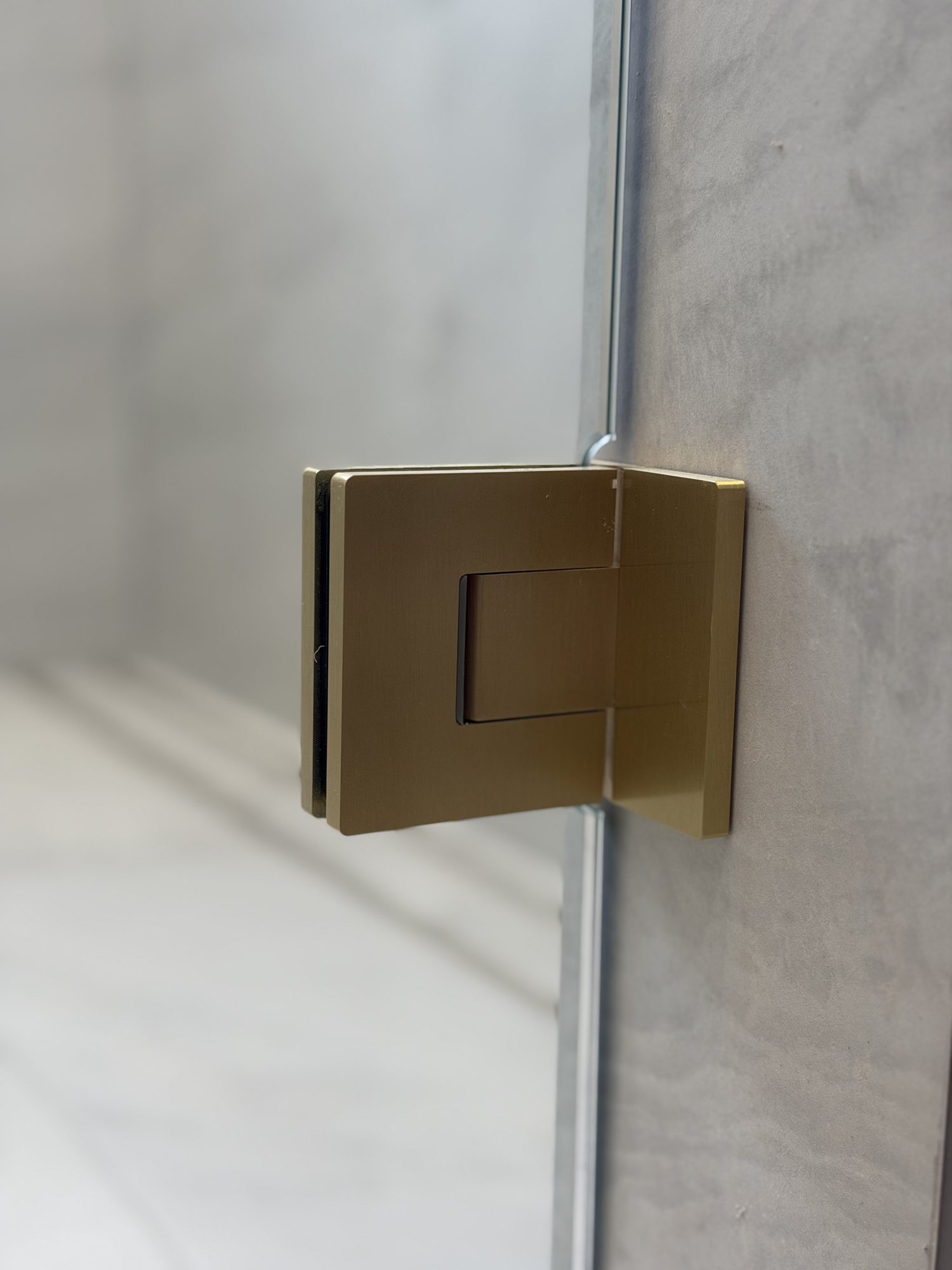Brushed brass hinge on curved-top panel — Adelaide, Unique Glass Solutions