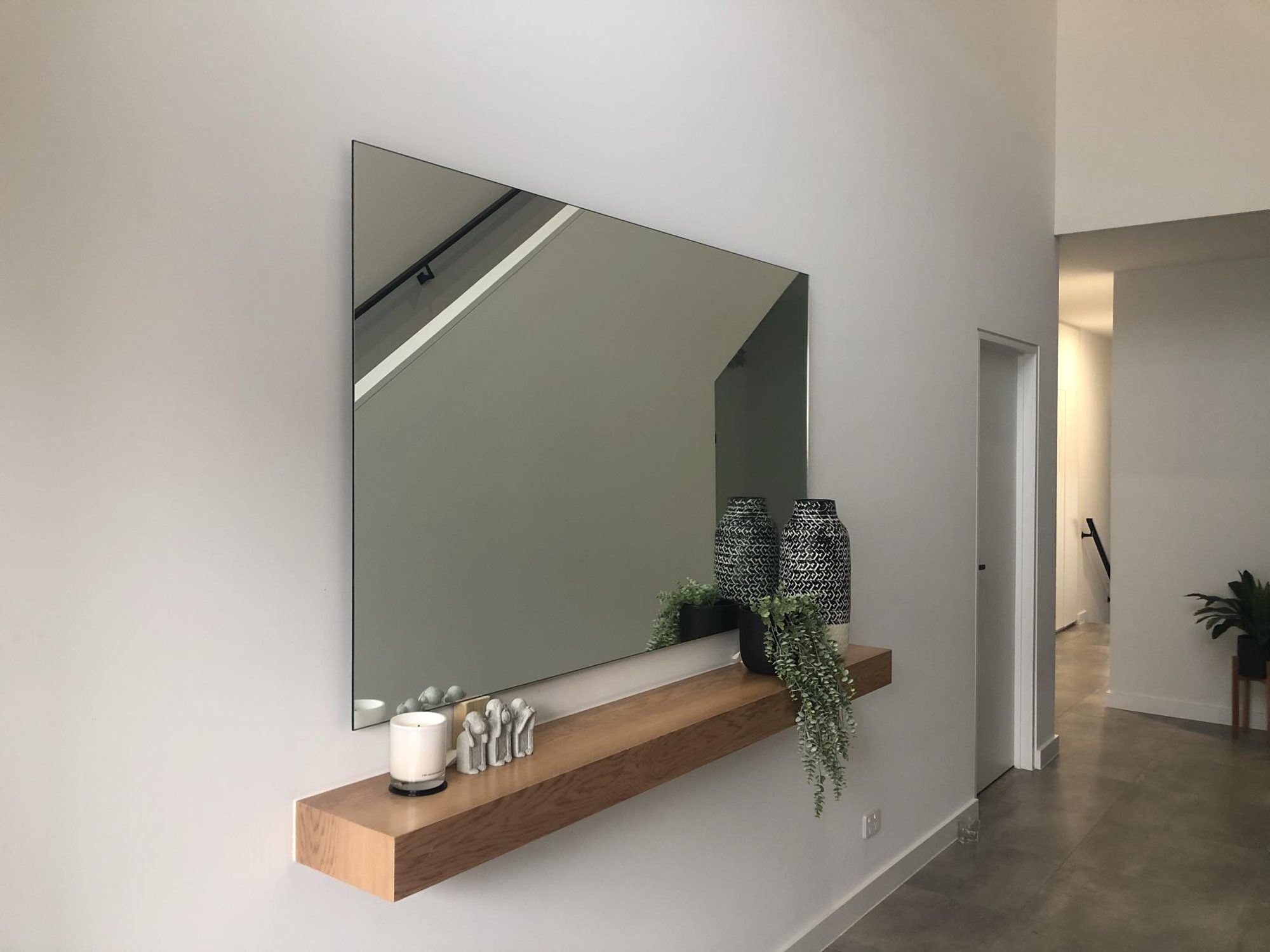 Tinted grey mirror above timber shelf, Adelaide