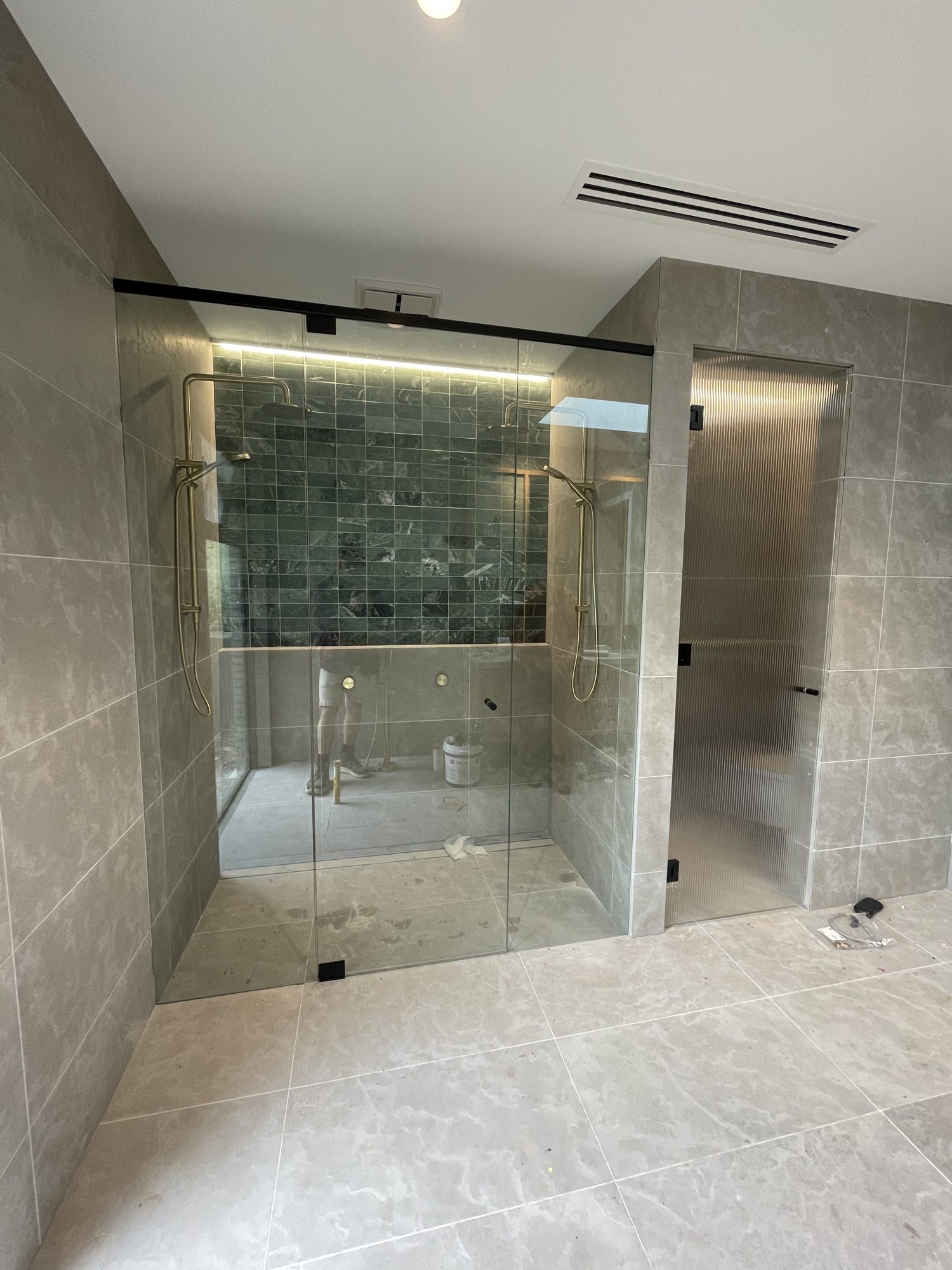 Designer ensuite with brass sliding shower screen — Unique Glass Solutions, Adelaide