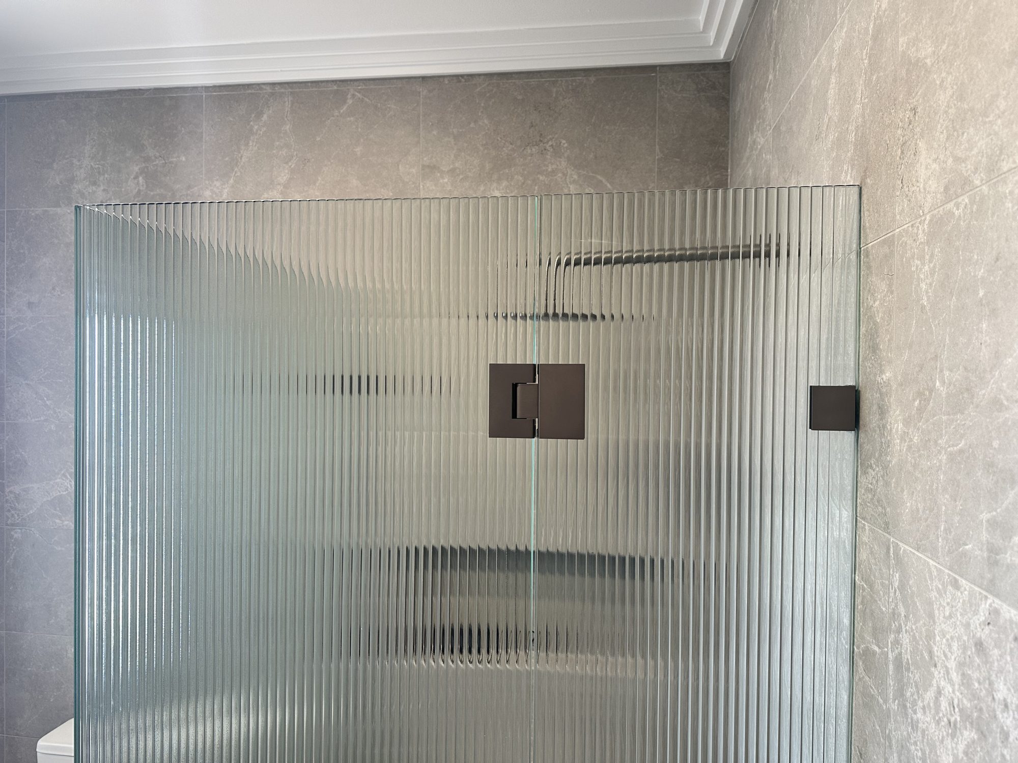 Reeded panel bronze hinge — Adelaide, Unique Glass Solutions