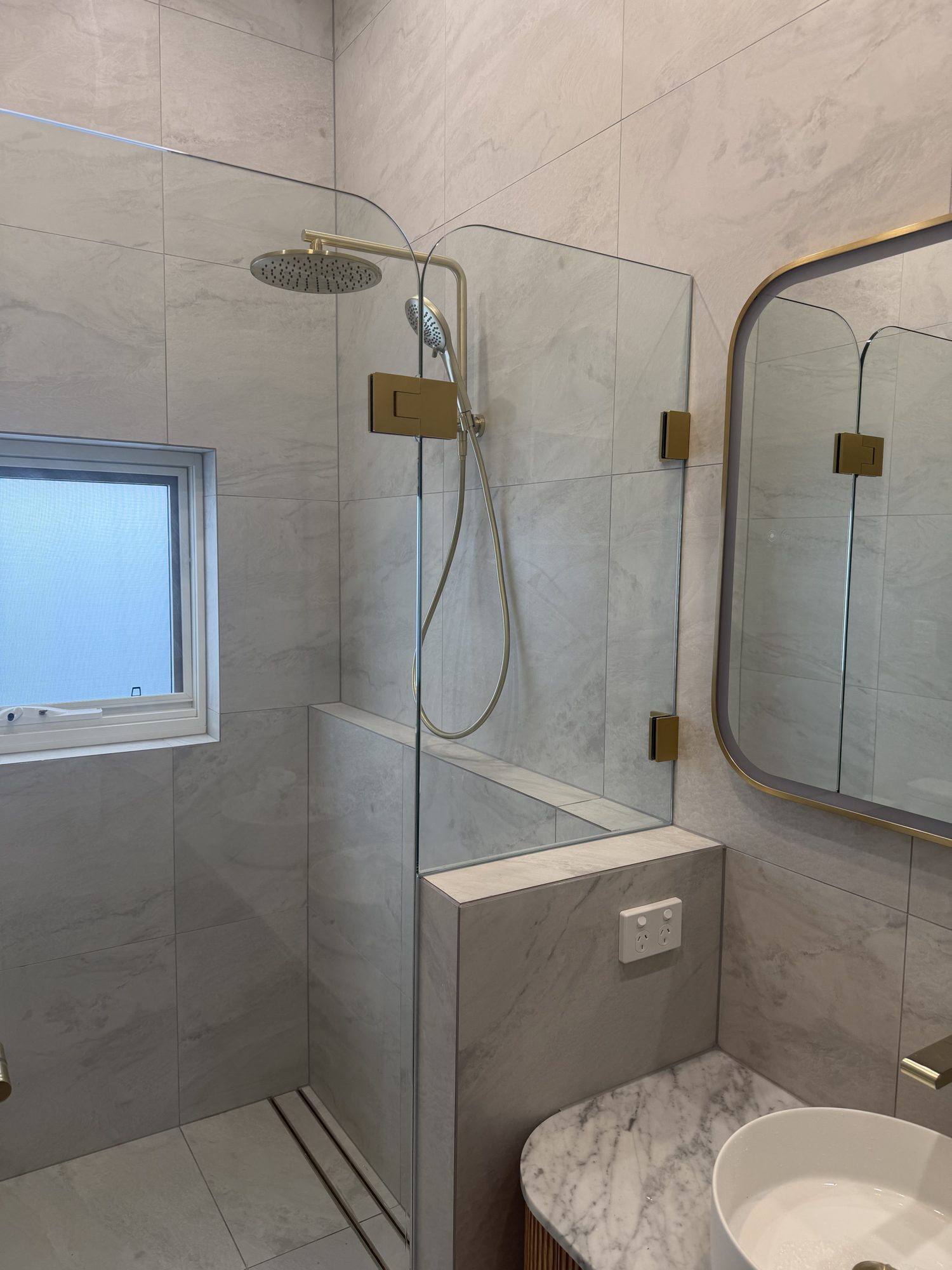 Curved-top frameless shower panels, brushed brass hardware — Adelaide, Unique Glass Solutions